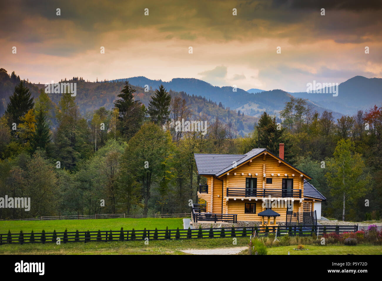 Autumn scenery in Bucovina with wooden cabin at sunset Stock Photo