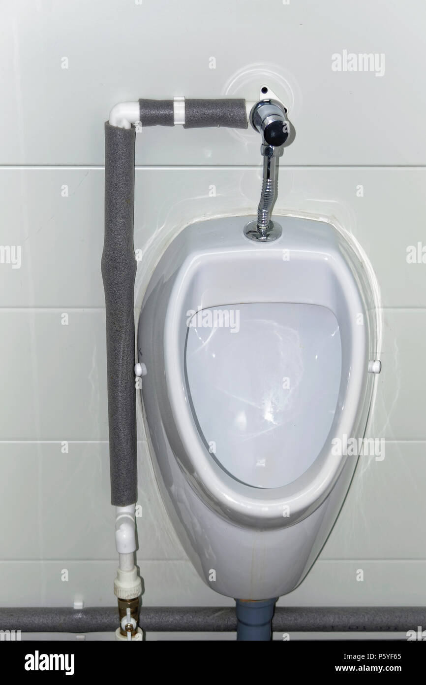 White urinal men in public toilet. Closeup Stock Photo Alamy