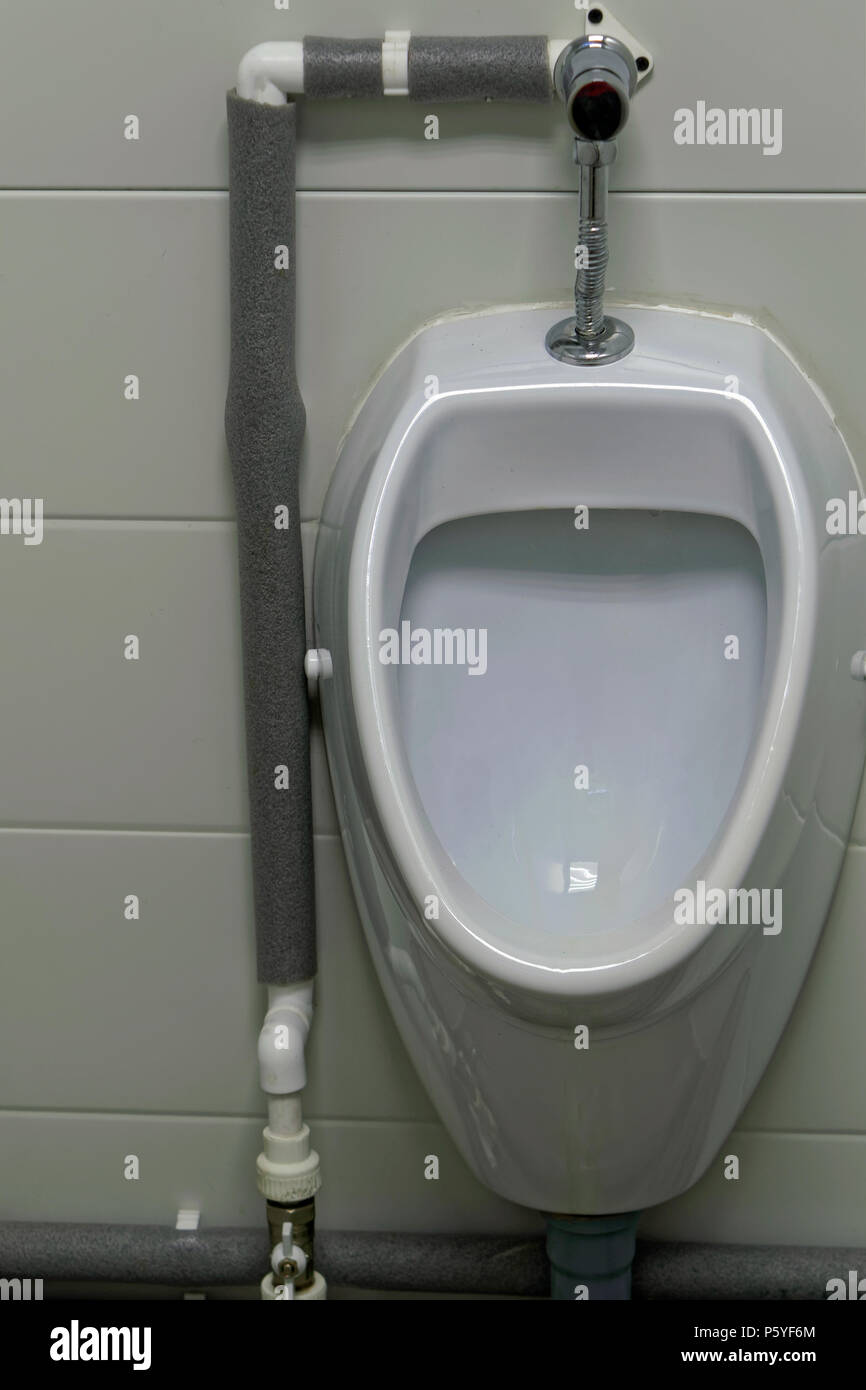 White urinal men in public toilet. Closeup Stock Photo Alamy