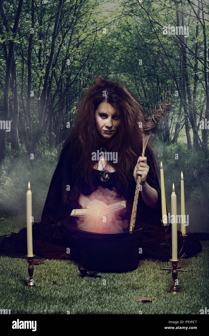 evil witch stirring her magic potion in a cauldron Stock Photo Alamy
