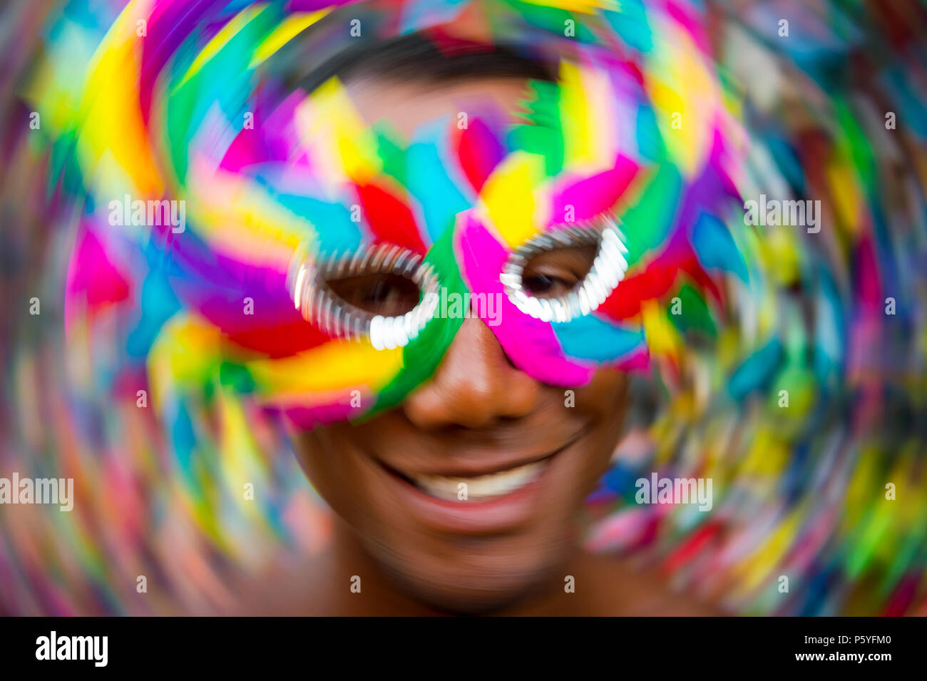 Salvador Carnival scene features samba dancing Brazilian man smiling in