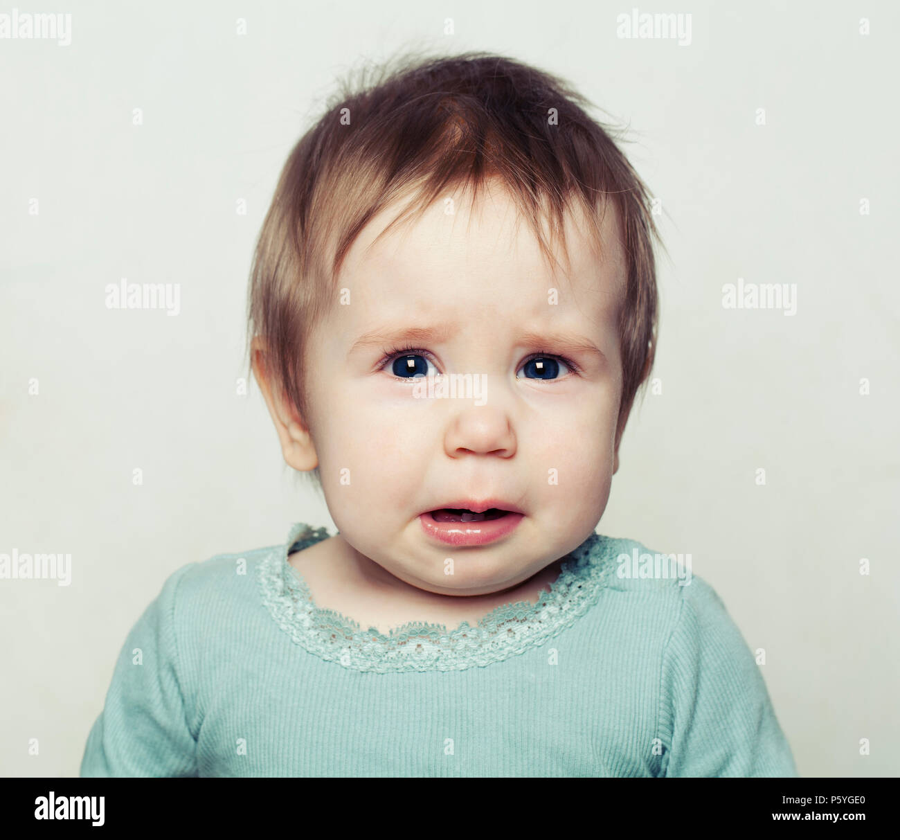 Small Baby Girl Crying. Sad Child Stock Photo