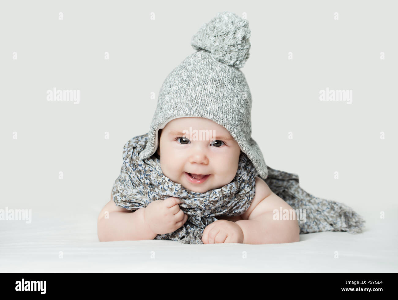 Cute small baby in knitted hat, portrait. Happy little child (3 months old) Stock Photo