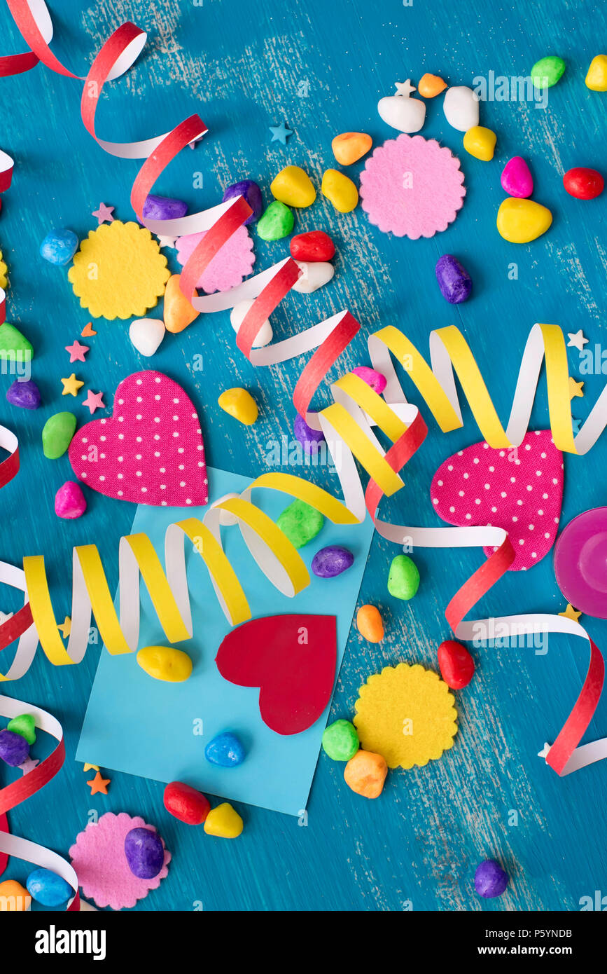 Festive confetti background heart candy color saturated. Wood old blue background with copy space flat lay Stock Photo