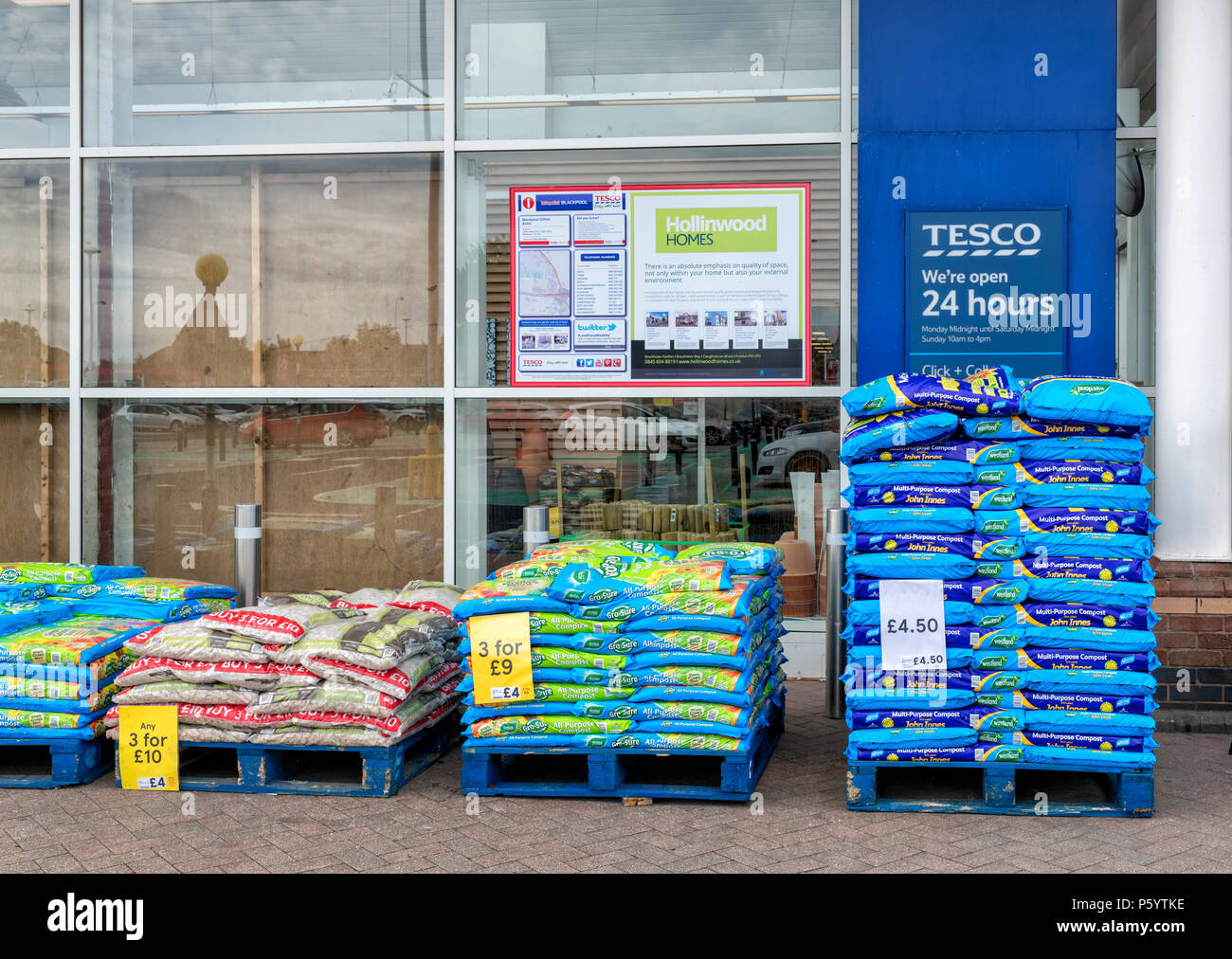 Bags of potting compost stacked up outside a Tesco supermarket Stock Photo