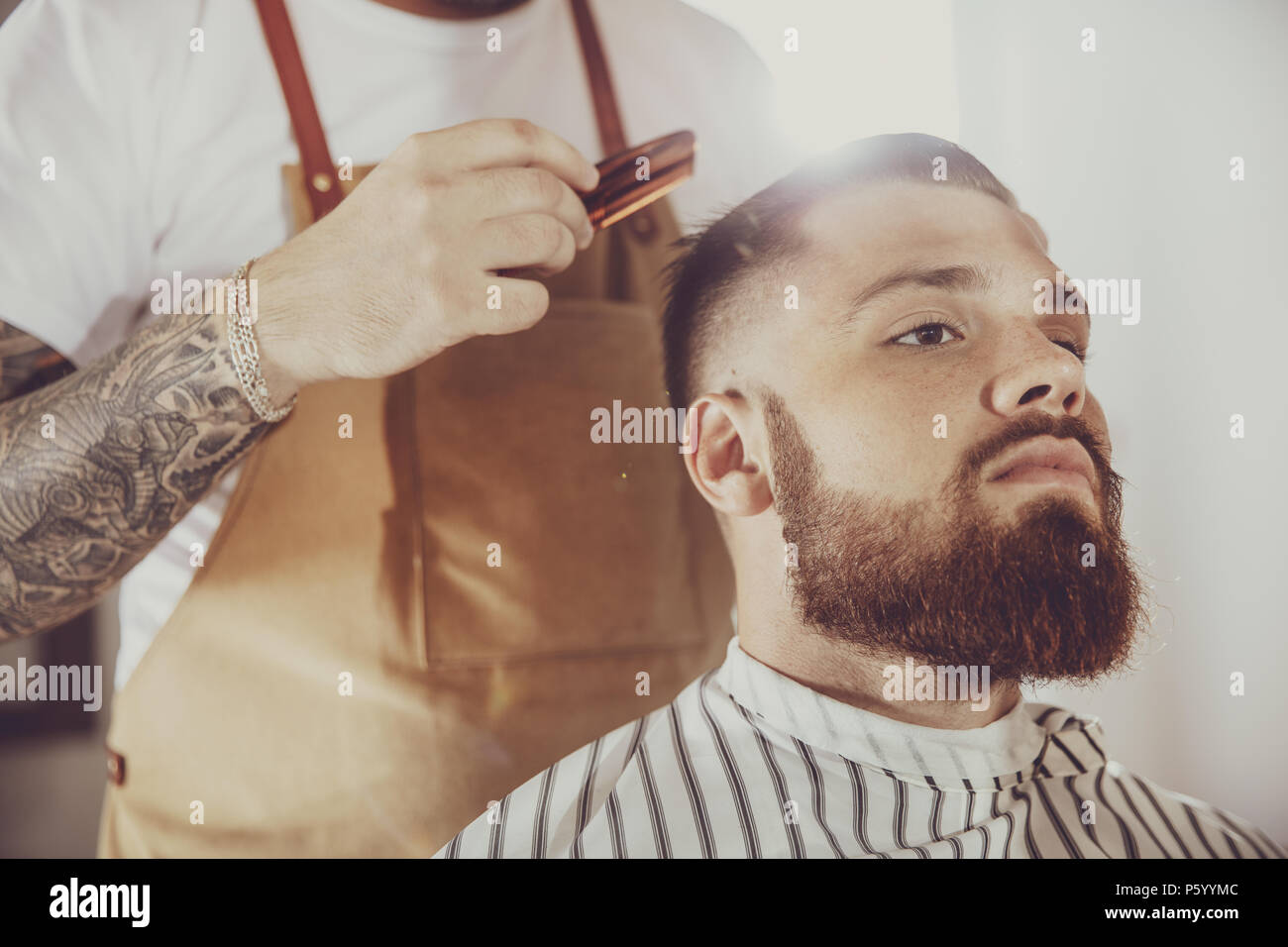 Man in the process of trimming a beard in a Photo in