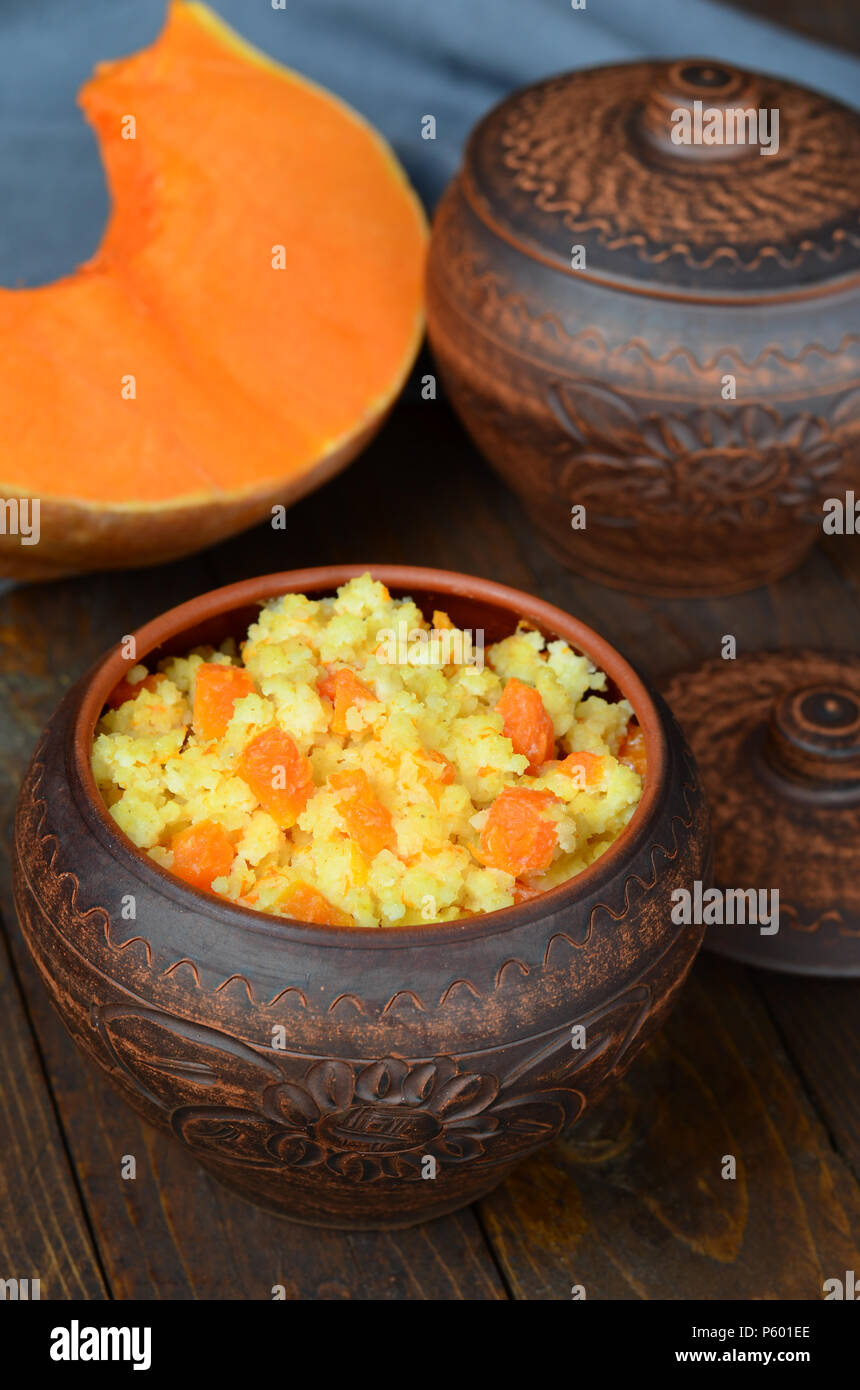 Millet porridge with pumpkin in clay pot Stock Photo Alamy