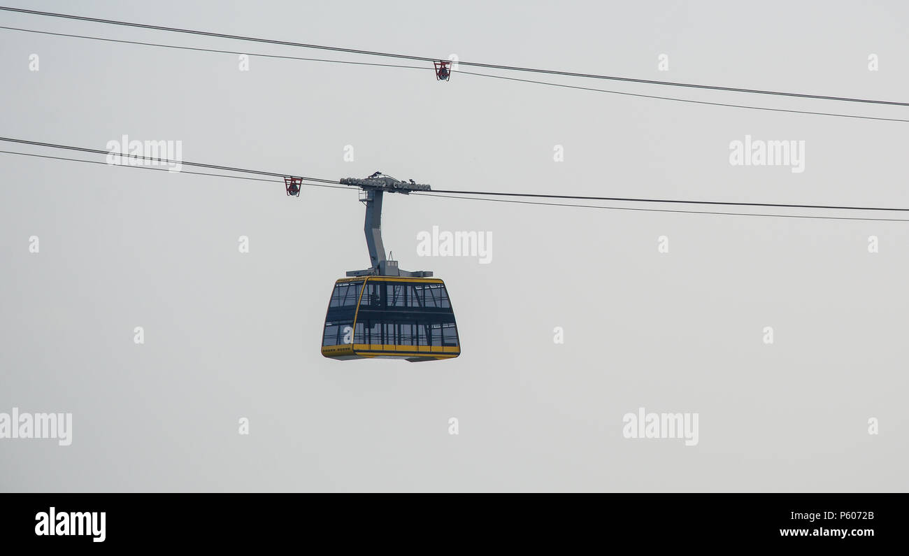 Cabin of the cable car against gray sky in misty day Stock Photo - Alamy