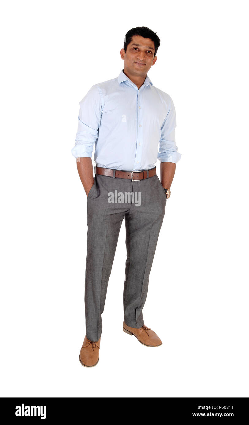 A tall East Indian man standing relaxed in dress pants and blue
