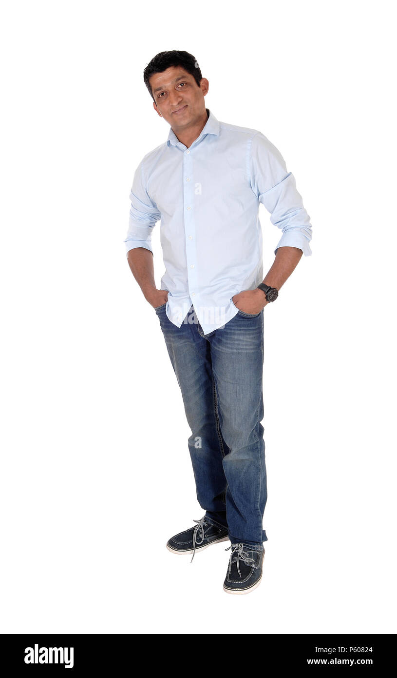 A tall East Indian man standing relaxed in jeans and blue shirt with his  hands in his pocket, isolated for white background Stock Photo - Alamy