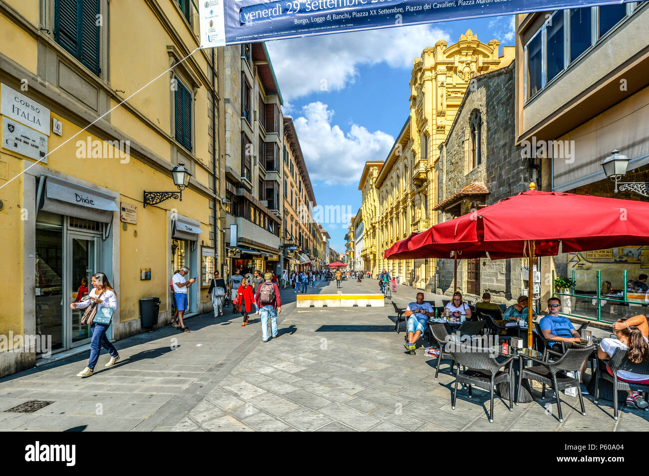 Tourists and locals enjoy a sunny day on the Corso Italia, the main shopping and dining street through the Tuscan city of Pisa, Italy Stock Photo