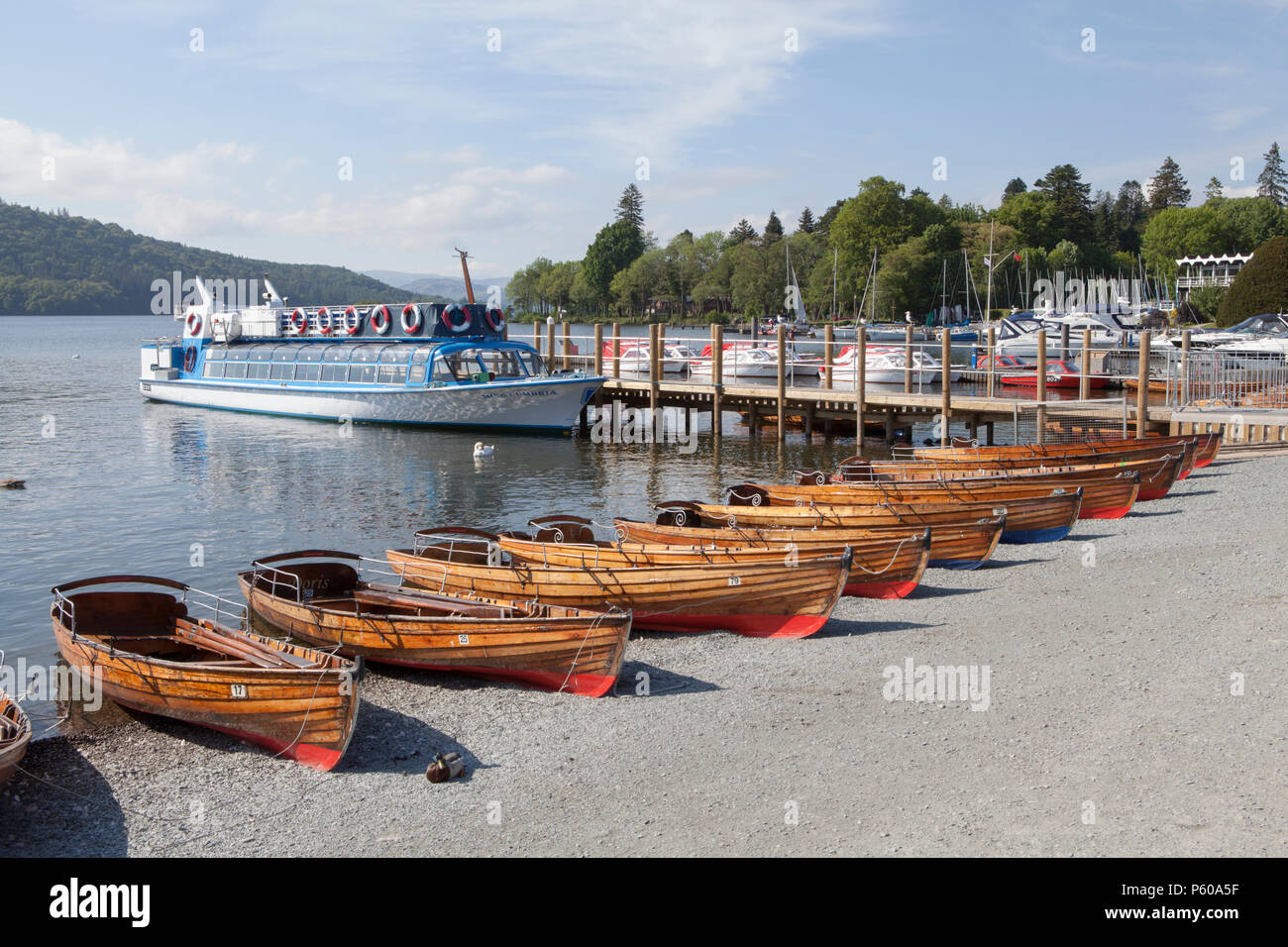 Rowing and rental boats lined up on the shore of Windermere a lake in