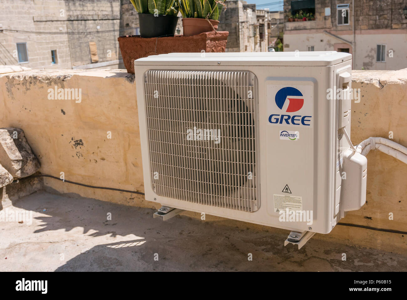 External heat exchanger unit of an air conditioning system made by Gree. Stock Photo