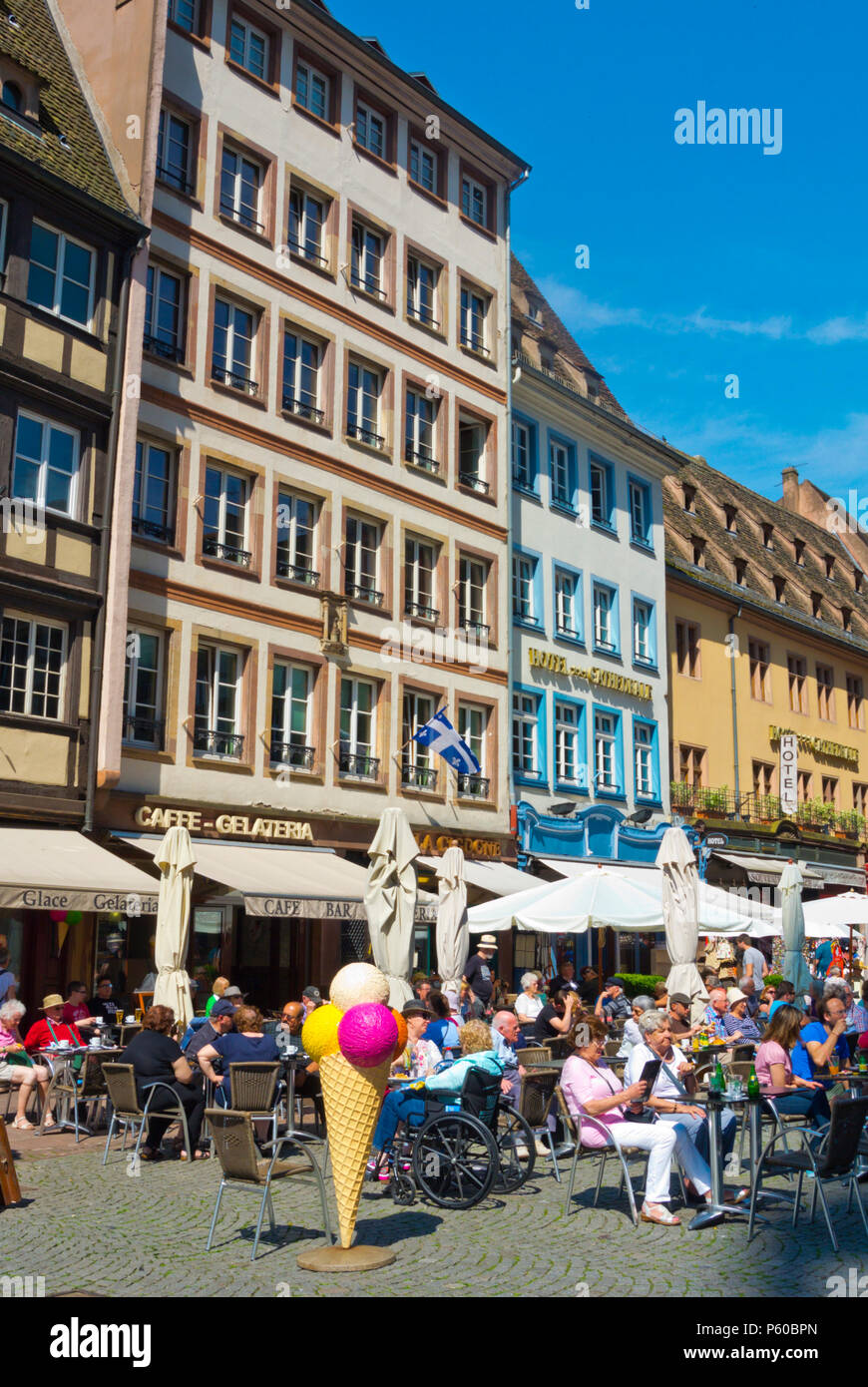 Cafe terraces for tourists, Place de la Cathedrale, Grande Ile, Strasbourg, Alsace, France Stock Photo