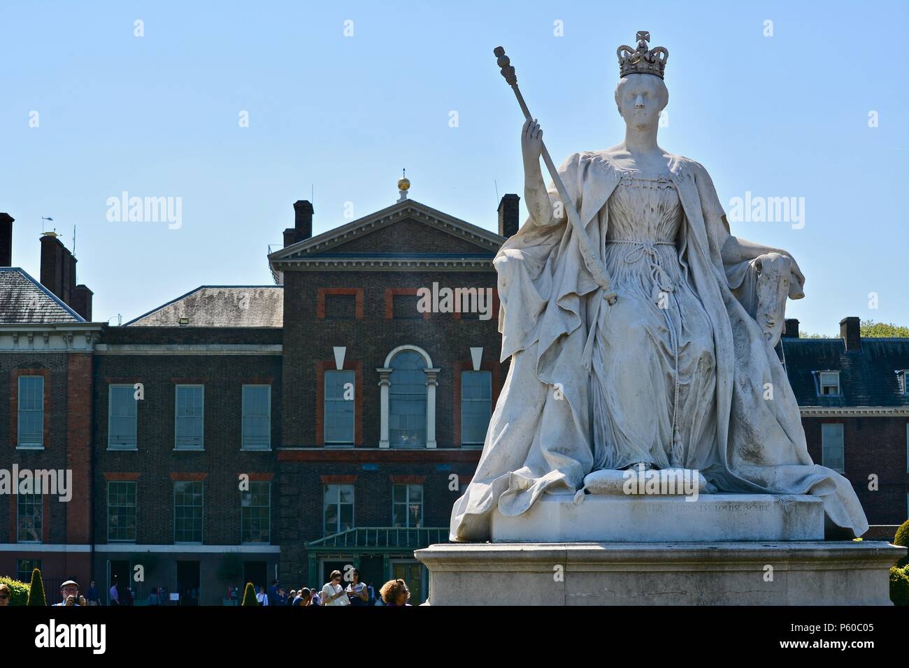 A statue of Queen Victoria in front of Kensington Palace in Kensington