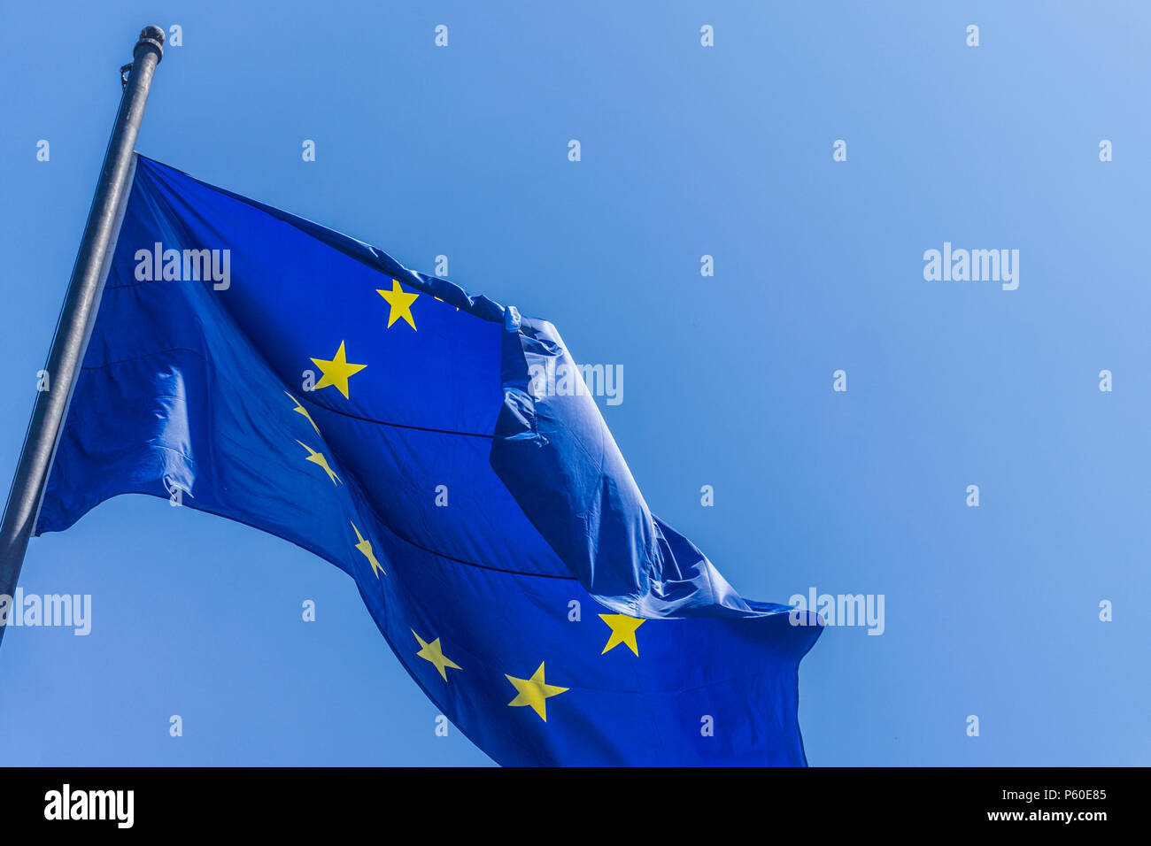 European union flag flying against a blue sky background Stock Photo ...