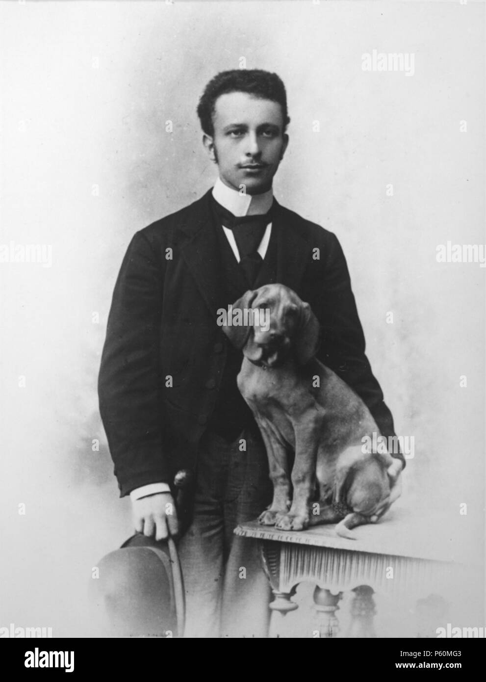 N/A. English: Photograph of the Austrian writer Felix Salten with a dog. circa 1895. Anonymous 552 Felix-Salten-1895 Stock Photo