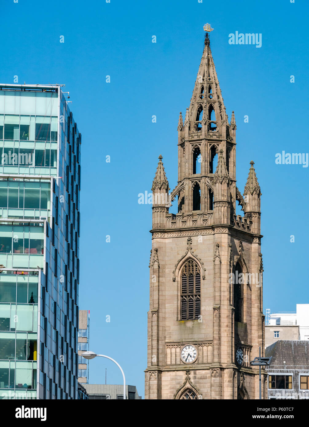 Close up view of ornate church spire with gold ship for navigation on top against blue sky Church of Our Lady and Saint Nicholas, Liverpool, England Stock Photo