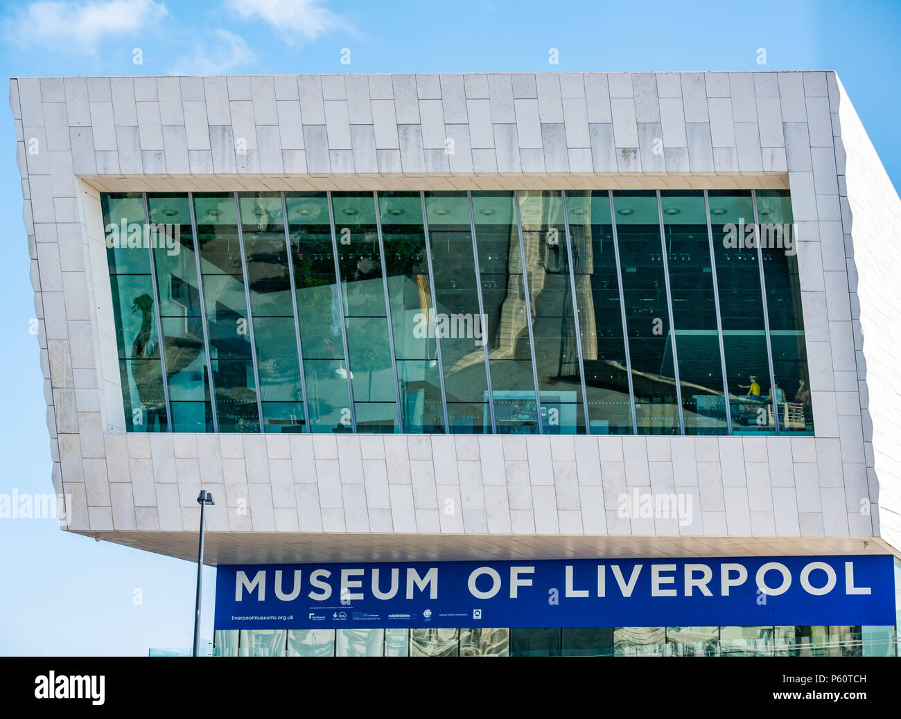 Street reflections on sunny day in window of striking modern glass building, Museum of Liverpool, Pier Head, Liverpool, England, UK Stock Photo