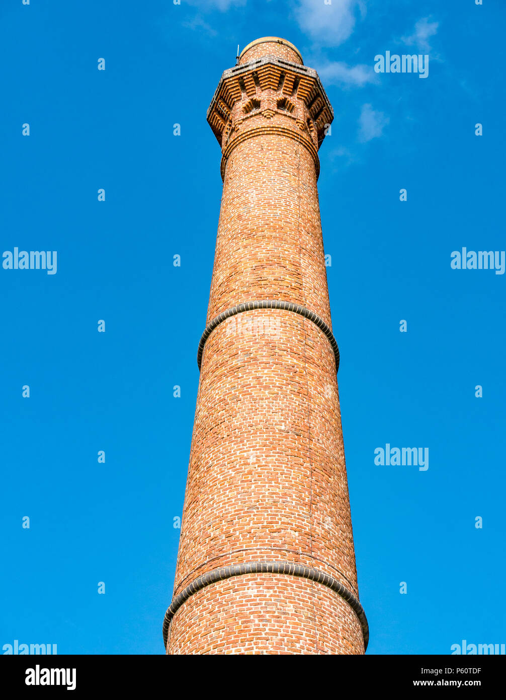 Tall round red brick Victorian industrial tower against blue sky, Canning graving dock and Albert Dock, Liverpool, England, UK Stock Photo