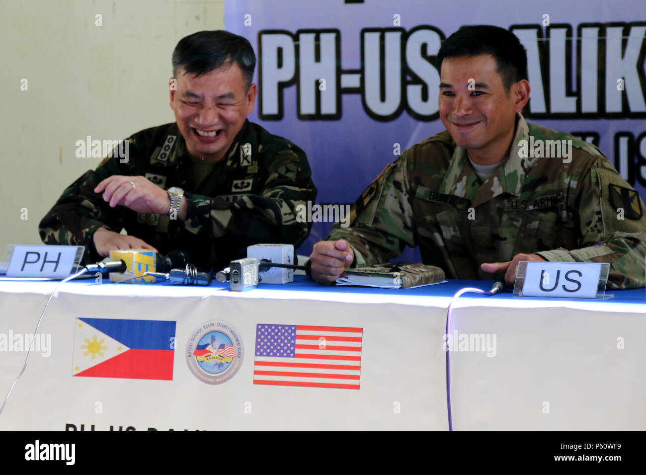 Colonel Roberto T. Ancan, chief of staff, 3rd Infantry Division, Armed Forces of the Philippines (AFP), left, and Maj. Alejandro L. Buniag, 303rd Maneuver Enhancement Brigade, 9th Mission Support Command, Combined Joint Civil Military Operation Task Force commander laugh together before the start of a press conference following the opening ceremony of Exercise Balikatan 2016 at Camp Peralta, Panay, Philippines, April 4, 2016. The ceremony signified the official start of the annual bilateral exercise that will run from 4-16 April. In Panay, Balikatan 2016 will consist of medical, dental, veteri Stock Photo