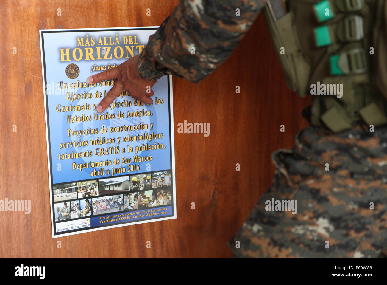 Guatemala Pfc. Roberto Lopez hang up a poster explaining the benefits of Beyond The Horizon in San Rafael, Guatemala, April 1, 2016.  Task Force Red Wolf and Army South conducts Humanitarian Civil Assistance Training to include tactical level construction projects and Medical Readiness Training Exercises providing medical access and building schools in Guatemala with the Guatemalan Government and non-government agencies from 05MAR16 to 18JUN16 in order to improve the mission readiness of US Forces and to provide a lasting benefit to the people of Guatemala.  (U.S. Army photo by Sgt. Ronquel Ro Stock Photo