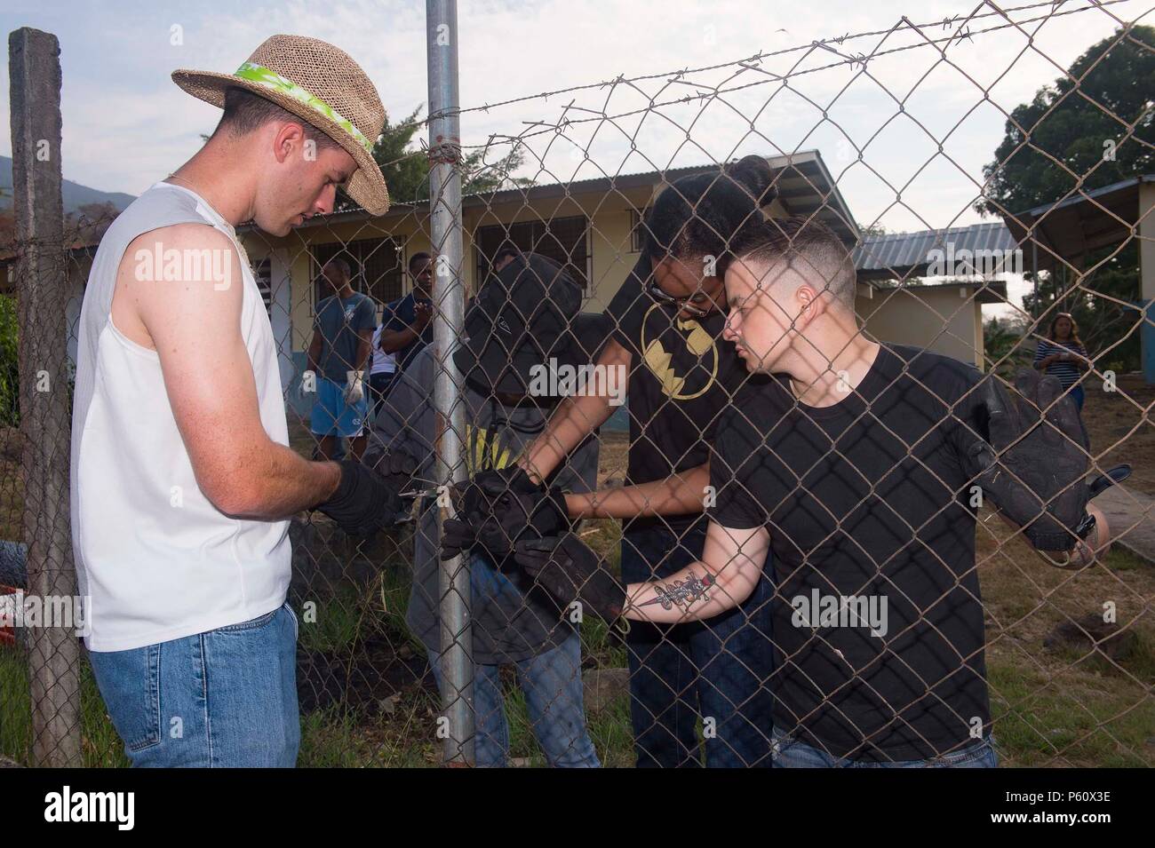 160402-N-MD297-002 VERACRUZ, Panama (April 2, 2016) Sailors from the Arleigh Burke-class guided-missile destroyer USS Lassen (DDG 82) replace a damaged fence at the Cosecha de Amistad School in Veracruz, Panama during a community service event with members of PanamaÕs Presidential Protective Service (SPI). Lassen is currently underway in support of Operation Martillo, a joint operation with the U.S. Coast Guard and partner nations within the 4th Fleet area of responsibility. Operation Martillo is being led by Joint Interagency Task Force South, in support of U.S. Southern Command. (U.S. Navy p Stock Photo