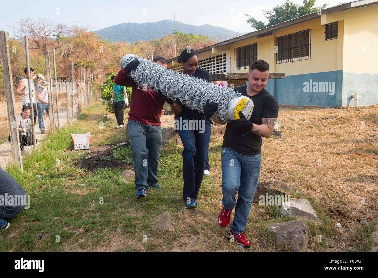 160402-N-MD297-007 VERACRUZ, Panama (April 2, 2016) Sailors from the Arleigh Burke-class guided-missile destroyer USS Lassen (DDG 82) carry fencing to replace a damaged fence at the Cosecha de Amistad School in Veracruz, Panama during a community service event with members of PanamaÕs Presidential Protective Service (SPI). Lassen is currently underway in support of Operation Martillo, a joint operation with the U.S. Coast Guard and partner nations within the 4th Fleet area of responsibility. Operation Martillo is being led by Joint Interagency Task Force South, in support of U.S. Southern Comm Stock Photo