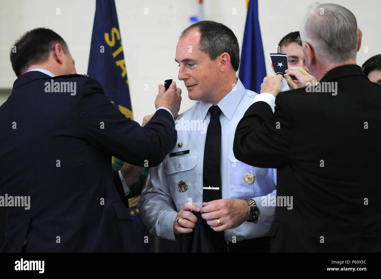 Maj. Gen. Michael Stencel, the Adjutant General (left), Oregon, assists Col. Kirk Pierce’s parents pin the rank of brigadier general on his shoulders during a promotion ceremony, April 3, 2016, at Kingsley Field in Klamath Falls, Oregon. Over the ensuing hour-and-a-half the 173rd Fighter Wing was commanded by a general officer for the first time, prior to a change of command ceremony where Col. Jeffrey Smith took over the wing. Pierce is heading to a staff position at the National Guard Bureau. (U.S. Air National Guard photo by Senior Airman Amber Powell/released) Stock Photo