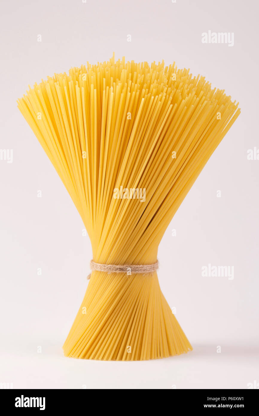 spaghetti tied with a brown thread. On a white background Stock Photo ...