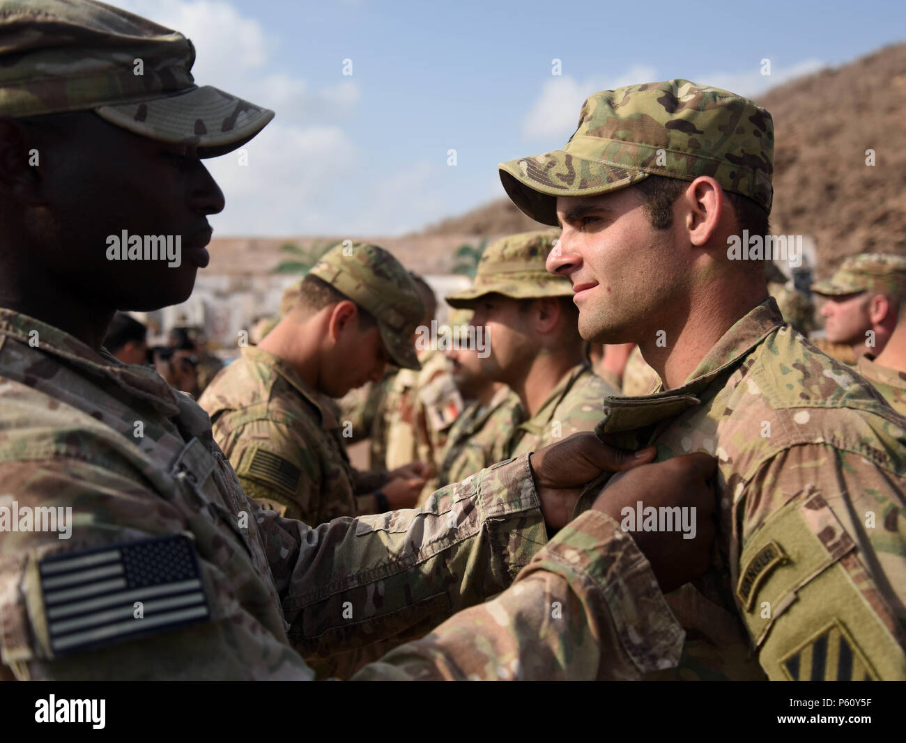 U.S. Army cadres pin badges on Soldiers during an Expert Infantry Badge pinning ceremony April 1
