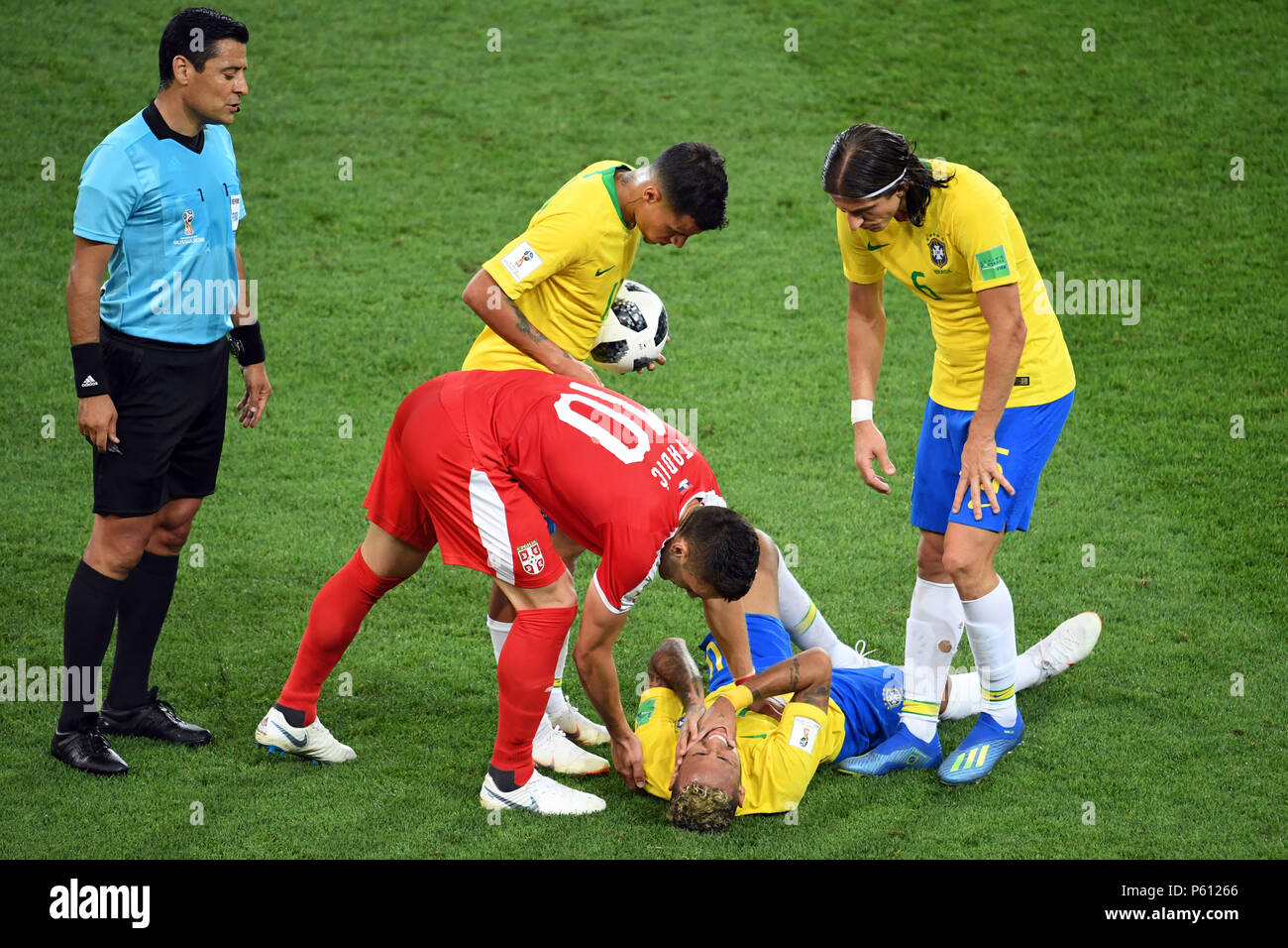 Moscow, Russia. 27th June, 2018. Soccer, World Cup, Serbia vs Brazil, group E, at the Spartak-Stadium. Brazil's Neymar is on the ground, as Serbia's Dusan Tadic bends over him, next to Iranian referee Alireza Faghani (l). Credit: Federico Gambarini/dpa/Alamy Live News Stock Photo
