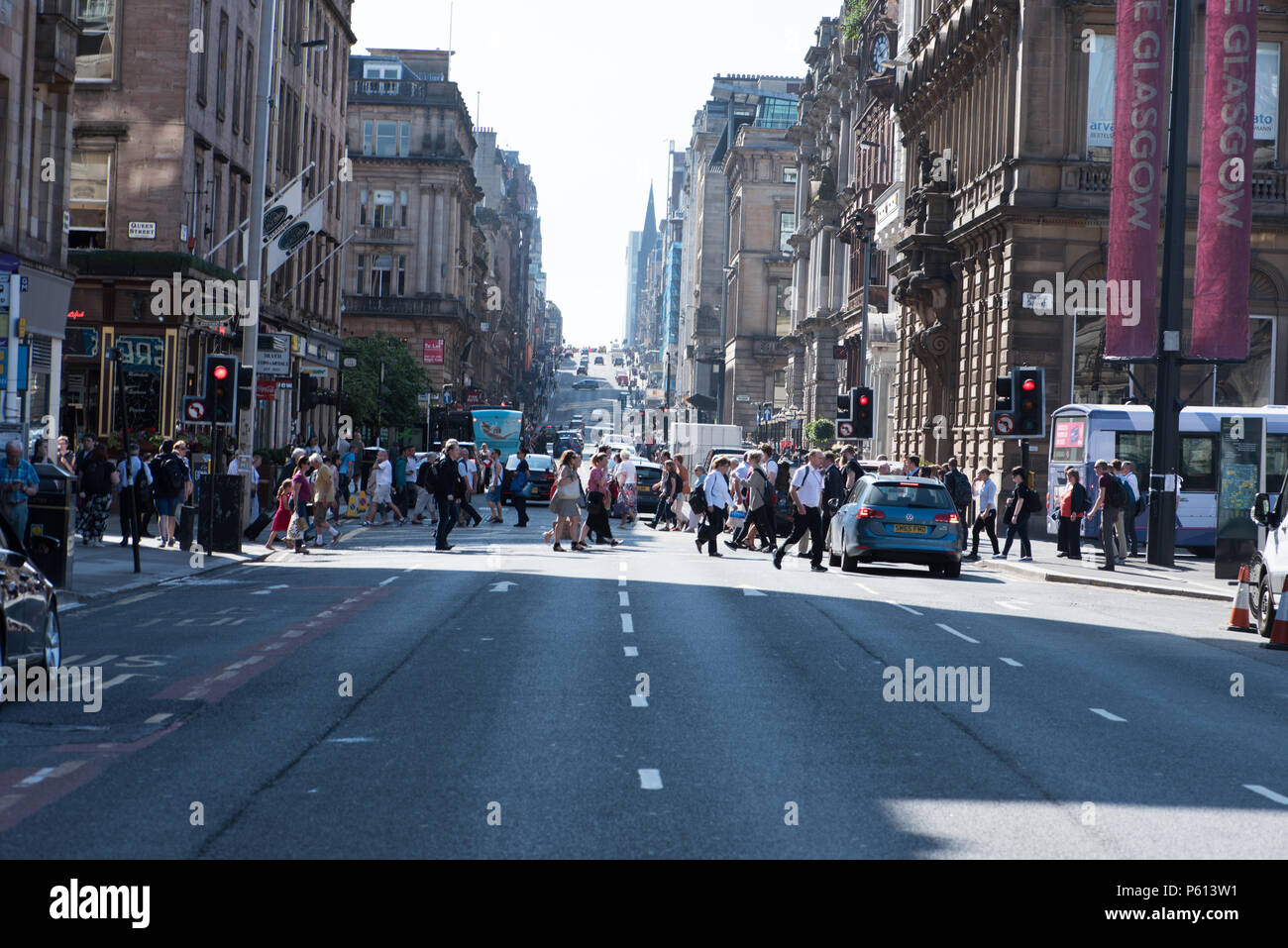 Glasgow, UK. 27th Jun, 2018. UK Weather: Crowds cross Buchanan Street and St Vincent Street junction in the sunshine Credit: Tony Clerkson/Alamy Live News Stock Photo