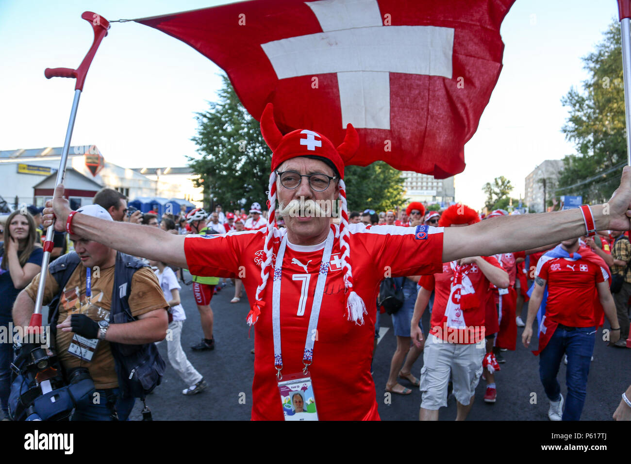A swiss football fan seen with their national flag. Hundreds of Swiss football fans seen before