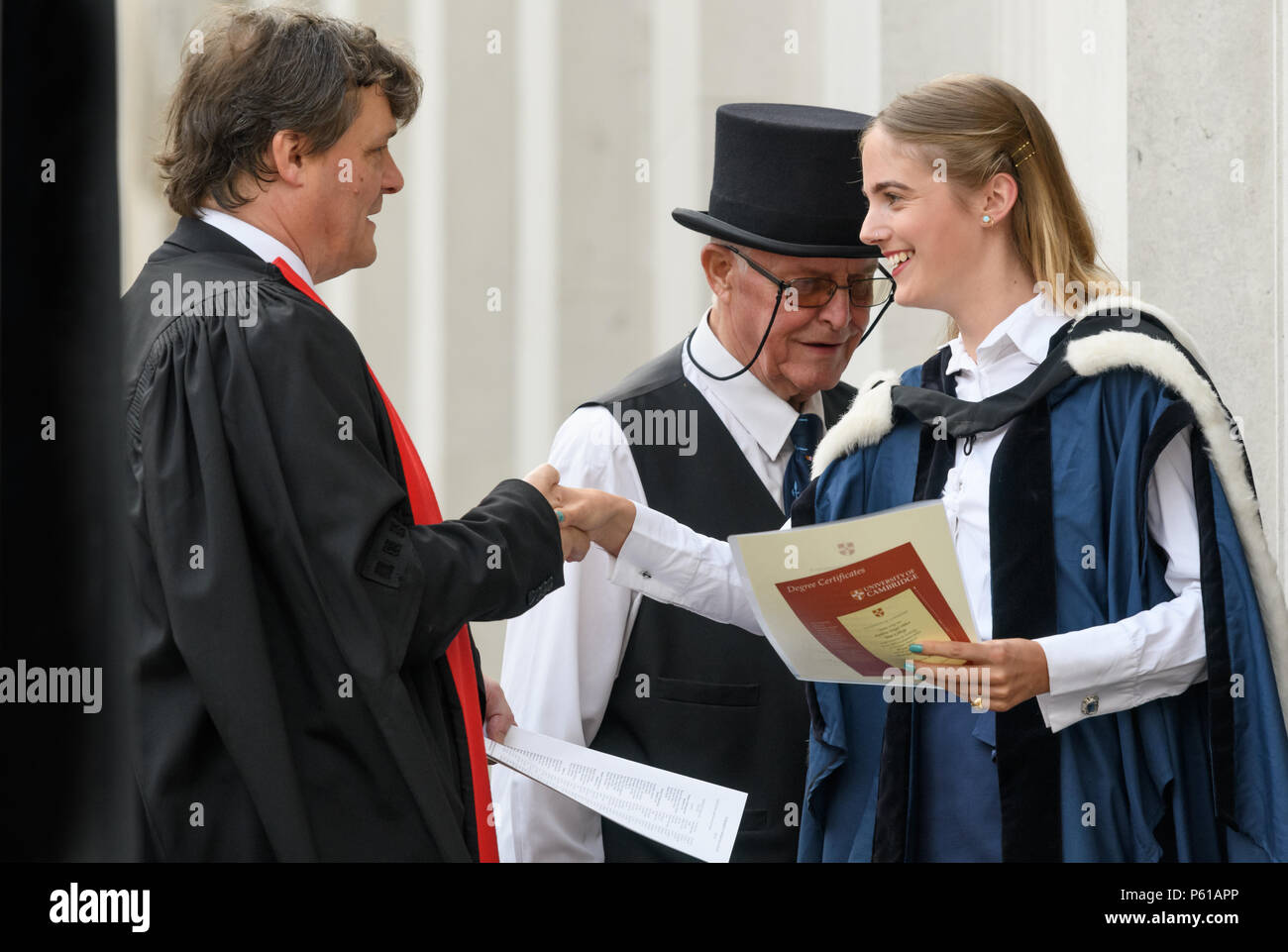 Cambridge University, UK. 28th Jun 2018. A delighted newly qualified  graduate of Gonville and Caius college, university of Cambridge, leaves  Senate House with her degree certificate after the graduation ceremony  there, and, image size:1300x961