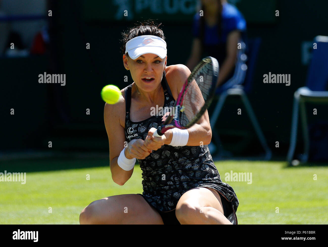 Devonshire Park, Eastbourne, UK. 28th June, 2018. Nature Valley  International Tennis; Agnieszka Radwanska (POL) drops low and plays a  backhand shot in her match against Jelena Ostapenko (LAT) Credit: Action  Plus Sports/Alamy