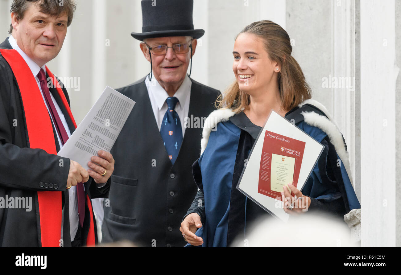 Cambridge, England. 28 June 2018. A delighted newly qualified graduate of  Gonville and Caius college, university of Cambridge, leaves Senate House  with her degree certificate after the graduation ceremony there, and after, image size:1300x892