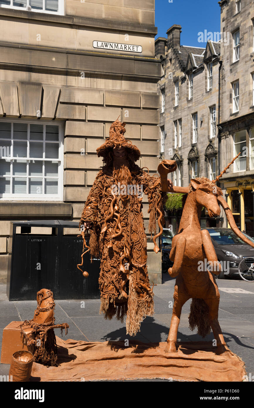 Levitating wizard dressed in snakes and lizards street performer on Lawnmarket on the Royal Mile Edinburgh Scotland UK Stock Photo
