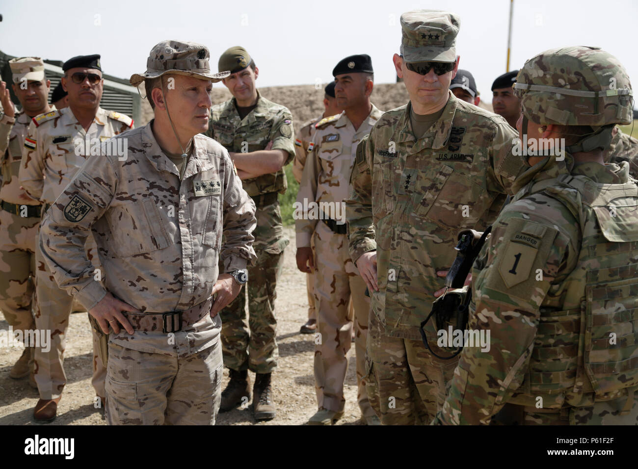 U.S. Army Lt. Gen. Sean MacFarland, center, commander of the Combined Joint Task Force - Operation Inherent Resolve, talks with U.S. Army trainers from 2nd Battalion, 70th Armored Regiment, 2nd Armored Brigade Combat Team, 1st Infantry Division, during his visit to the Besmaya Range Complex, Iraq, April 6, 2016. MacFarland visited the Building Partner Capacity site to review current training, learn about future training capabilities and to discuss needs of the Iraqi Army. The Besmaya Range Complex is one of four CJTF-OIR BPC locations dedicated to training Iraqi Security Forces.  (U.S. Army ph Stock Photo