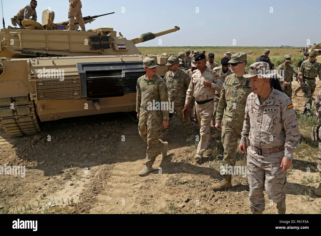 U.S. Army Lt. Gen. Sean MacFarland, center-right, commander of the Combined Joint Task Force - Operation Inherent Resolve, talks with U.S. Army trainers from 2nd Battalion, 70th Armored Regiment, 2nd Armored Brigade Combat Team, 1st Infantry Division, during his visit to the Besmaya Range Complex, Iraq, April 6, 2016. MacFarland visited the Building Partner Capacity site to review current training, learn about future training capabilities and to discuss needs of the Iraqi Army. The Besmaya Range Complex is one of four CJTF-OIR BPC locations dedicated to training Iraqi Security Forces.  (U.S. A Stock Photo