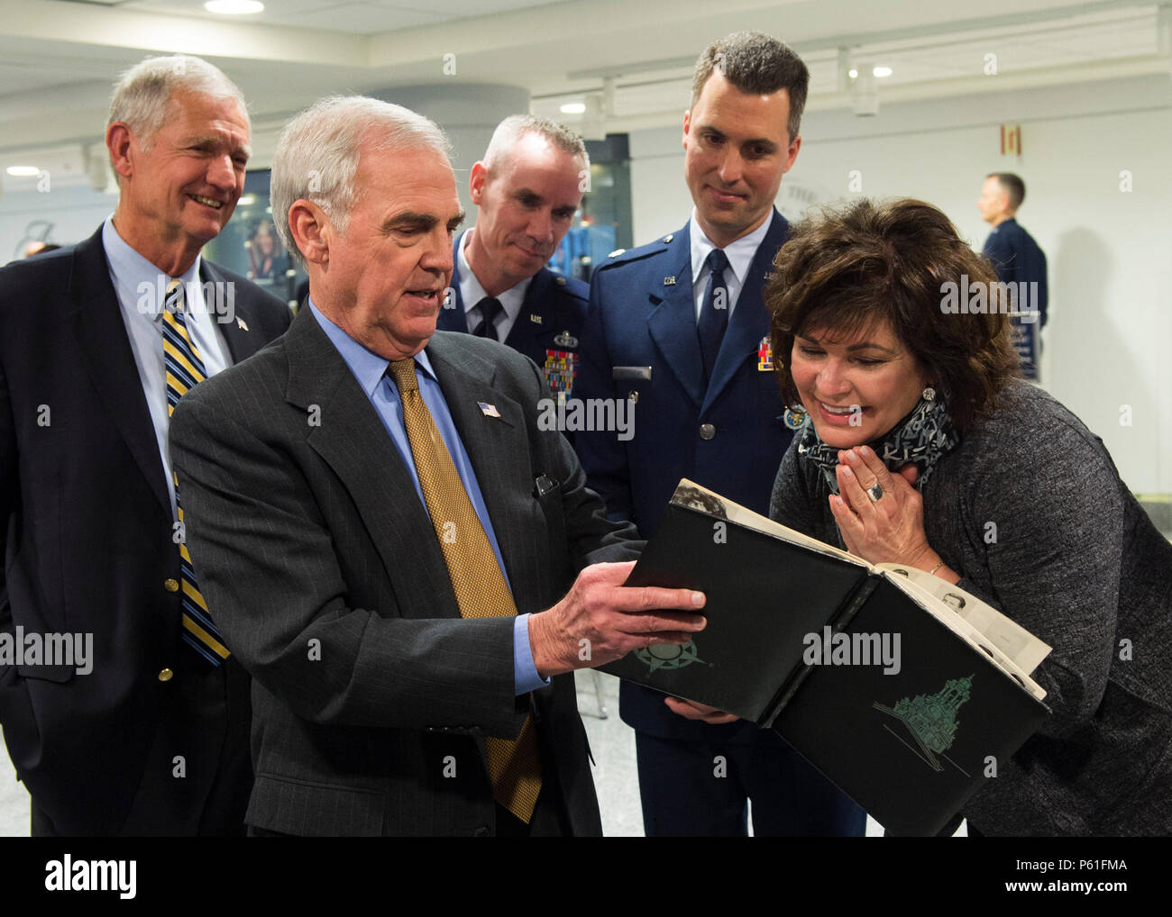 Following A Ceremony In The Pentagon Ms Janine Rozina The Sister Of Lance P Sijan Looks At Photos Of Her Brother Being Shown To Her By One Her Brother S Air Force Academy