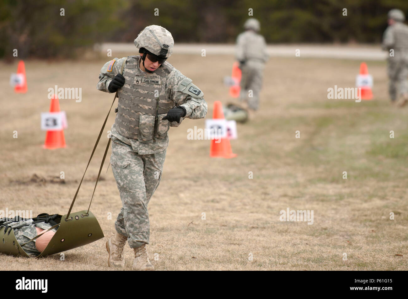 Staff Sgt. Jennifer Salomon, a military police operations noncommissioned  officer with Headquarters and Headquarters Company, 157th Maneuver  Enhancement Brigade, drags a Sked as part of the stress fire event during  the 2016