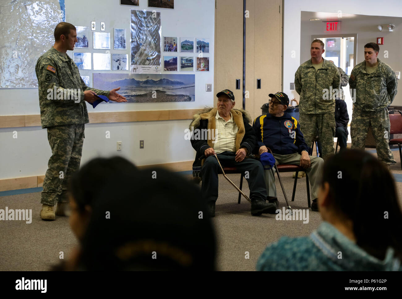 Col. Charles “Lee” Knowles, 297th Battlefield Surveillance Brigade commander, recognizes David U. Leavitt (left) and Wesley Atkin, the two remaining Alaska Territorial Guard Soldiers of Barrow, during the cultural day event held at the Inupiat Heritage Center in Barrow, April 6, 2016. The cultural exchange marked the conclusion of a vigorous week of annual training by Guard members assigned to the Anchorage-based 297th Battlefield Surveillance Brigade, Alaska Army National Guard. (U.S. Army National Guard photo by Sgt. Marisa Lindsay) Stock Photo