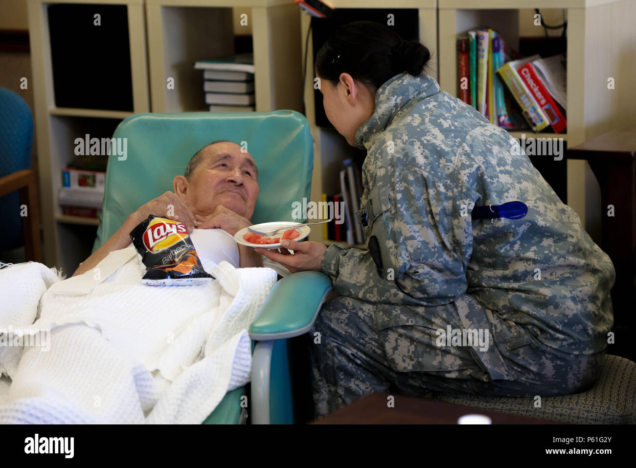 Soldiers with the 297th Battlefield Surveillance Brigade visit and bring food to the residents of Aimaagvik, an assisted living center, after the cultural day event held in Barrow, April 6. The cultural exchange marked the conclusion of a vigorous week of annual training by Guard members assigned to the Anchorage-based 297th Battlefield Surveillance Brigade, Alaska Army National Guard. (U.S. Army National Guard photo by Sgt. Marisa Lindsay) Stock Photo