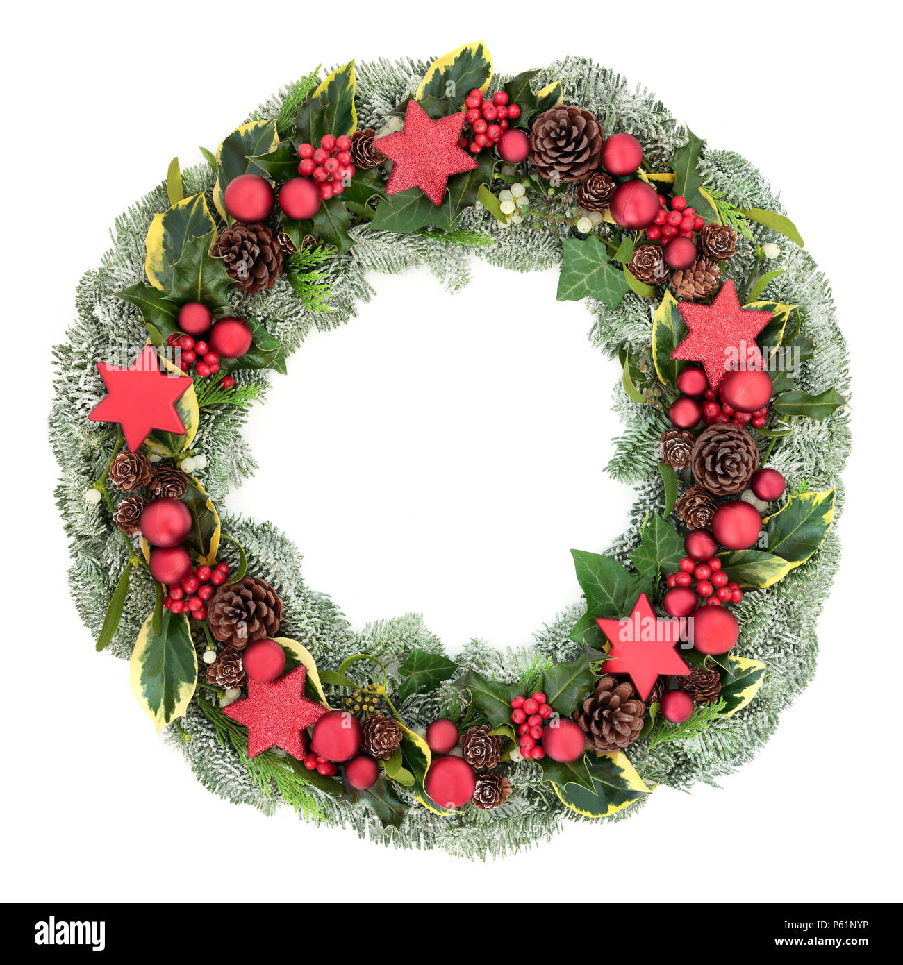 Christmas wreath with red bauble decorations, winter flora of holly, mistletoe, ivy, snow covered spruce fir and pine cones isolated on white backgrou Stock Photo