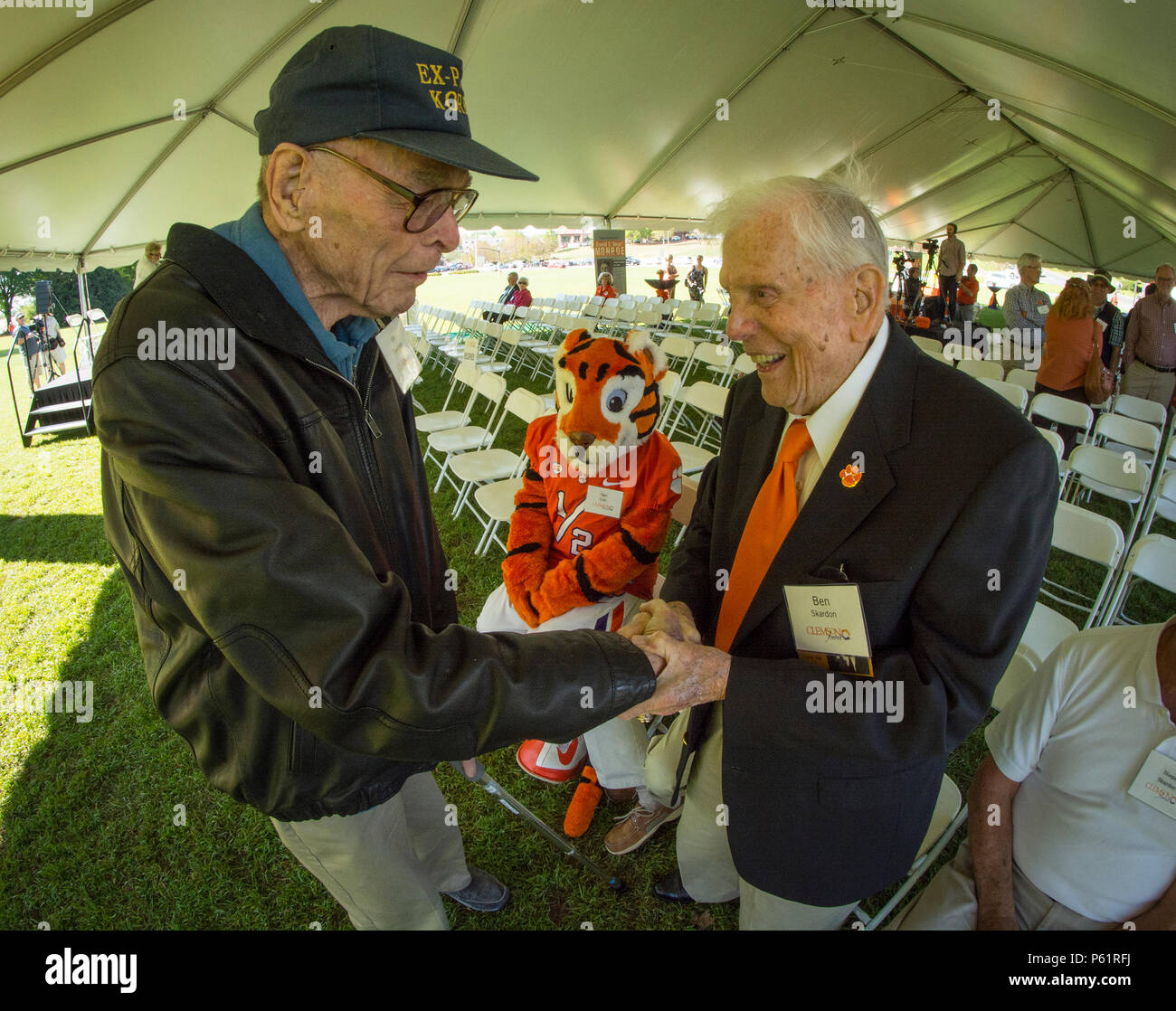 Korean War veteran and P.O.W. Bill Funchess greets World War II veteran and P.O.W. Ben Skardon during Clemson University's Reserve Officers' Training Corps 100th anniversary celebration, April 14, 2016. Both men graduated from Clemson's ROTC program - Skardon in 1938 and Funchess in 1948. (Photo by Ken Scar) Stock Photo