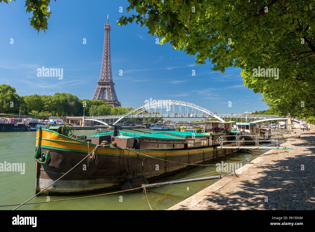 Paris, France - 23 June 2018: Residential barge on the Seine River with Eiffel Tower in background Stock Photo