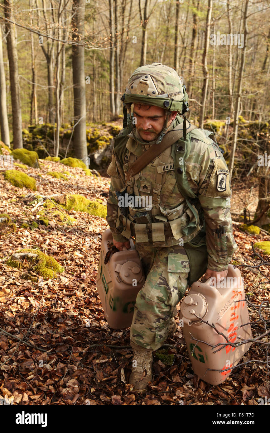 A U.S. Soldier of 1st Battalion, 503rd Infantry Regiment, 173rd Airborne Brigade moves supplies uphill while setting up a scouting position during exercise Saber Junction 16 at the U.S. Army’s Joint Multinational Readiness Center (JMRC) in Hohenfels, Germany, April 14, 2016. Saber Junction 16 is the U.S. Army Europe’s 173rd Airborne Brigade’s combat training center certification exercise, taking place at the JMRC in Hohenfels, Germany, Mar. 31-Apr. 24, 2016.  The exercise is designed to evaluate the readiness of the Army’s Europe-based combat brigades to conduct unified land operations and pro Stock Photo