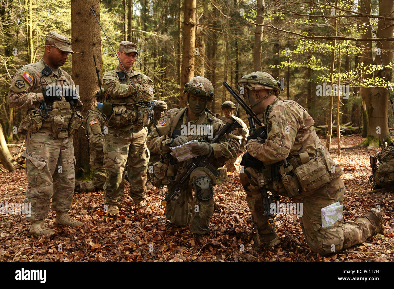 U.S. Soldiers of 1st Battalion, 503rd Infantry Regiment, 173rd Airborne Brigade confirm their location as part of scouting training mission during exercise Saber Junction 16 at the U.S. Army’s Joint Multinational Readiness Center (JMRC) in Hohenfels, Germany, April 14, 2016. Saber Junction 16 is the U.S. Army Europe’s 173rd Airborne Brigade’s combat training center certification exercise, taking place at the JMRC in Hohenfels, Germany, Mar. 31-Apr. 24, 2016.  The exercise is designed to evaluate the readiness of the Army’s Europe-based combat brigades to conduct unified land operations and pro Stock Photo