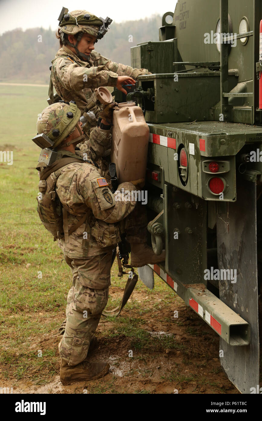 U.S. Soldiers of 1st Squadron, 91st Cavalry Regiment, 173rd Airborne Brigade fill a container with potable water while preparing for a patrol during exercise Saber Junction 16 at the U.S. Army’s Joint Multinational Readiness Center (JMRC) in Hohenfels, Germany, April 15, 2016. Saber Junction 16 is the U.S. Army Europe’s 173rd Airborne Brigade’s combat training center certification exercise, taking place at the JMRC in Hohenfels, Germany, Mar. 31-Apr. 24, 2016.  The exercise is designed to evaluate the readiness of the Army’s Europe-based combat brigades to conduct unified land operations and p Stock Photo